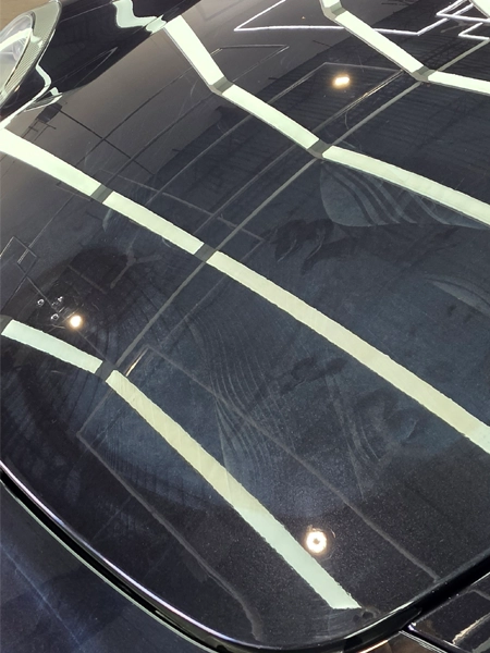 Old PPF adhesive residue visible on Porsche 911 hood